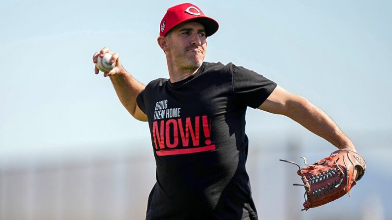 Reds coach Alon Leichman shows off ‘Bring Them Home Now!’ glove in support of Israel