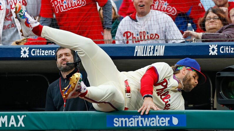 Phillies’ Bryce Harper flips upside down trying to catch ball in dugout